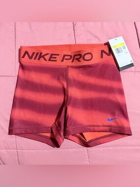 Nike Pro Women's Coral-Red Bike Shorts with Blue Swoosh